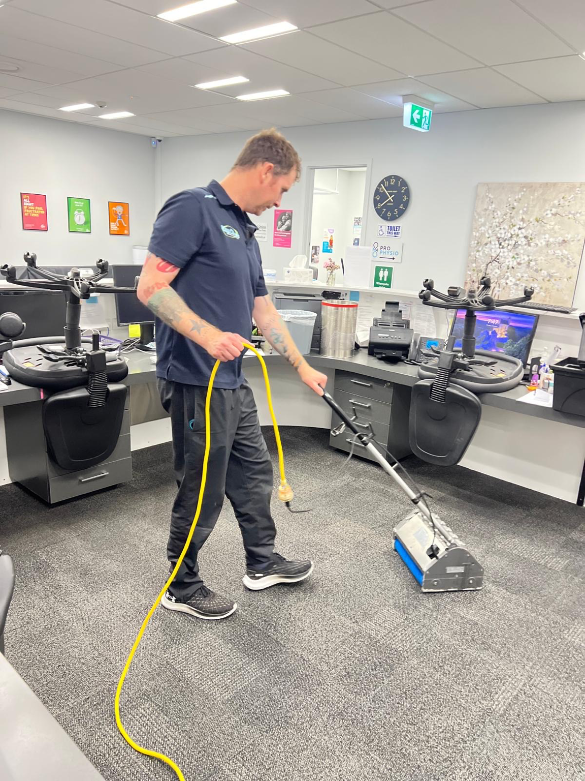 Professional carpet cleaning technician cleaning commercial carpet